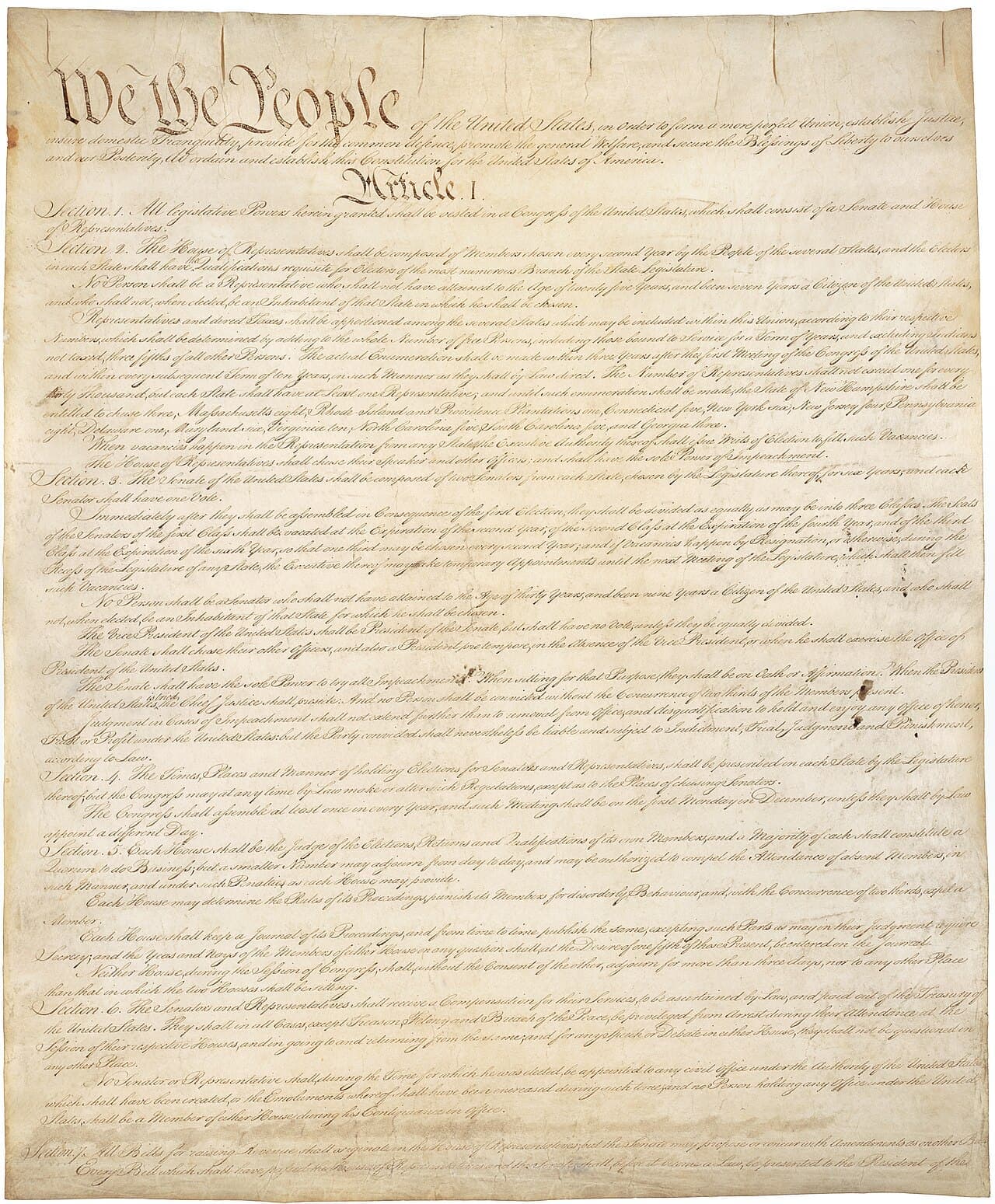 The first page of the engrossed United States Constitution, opening with the words We the People in large script.