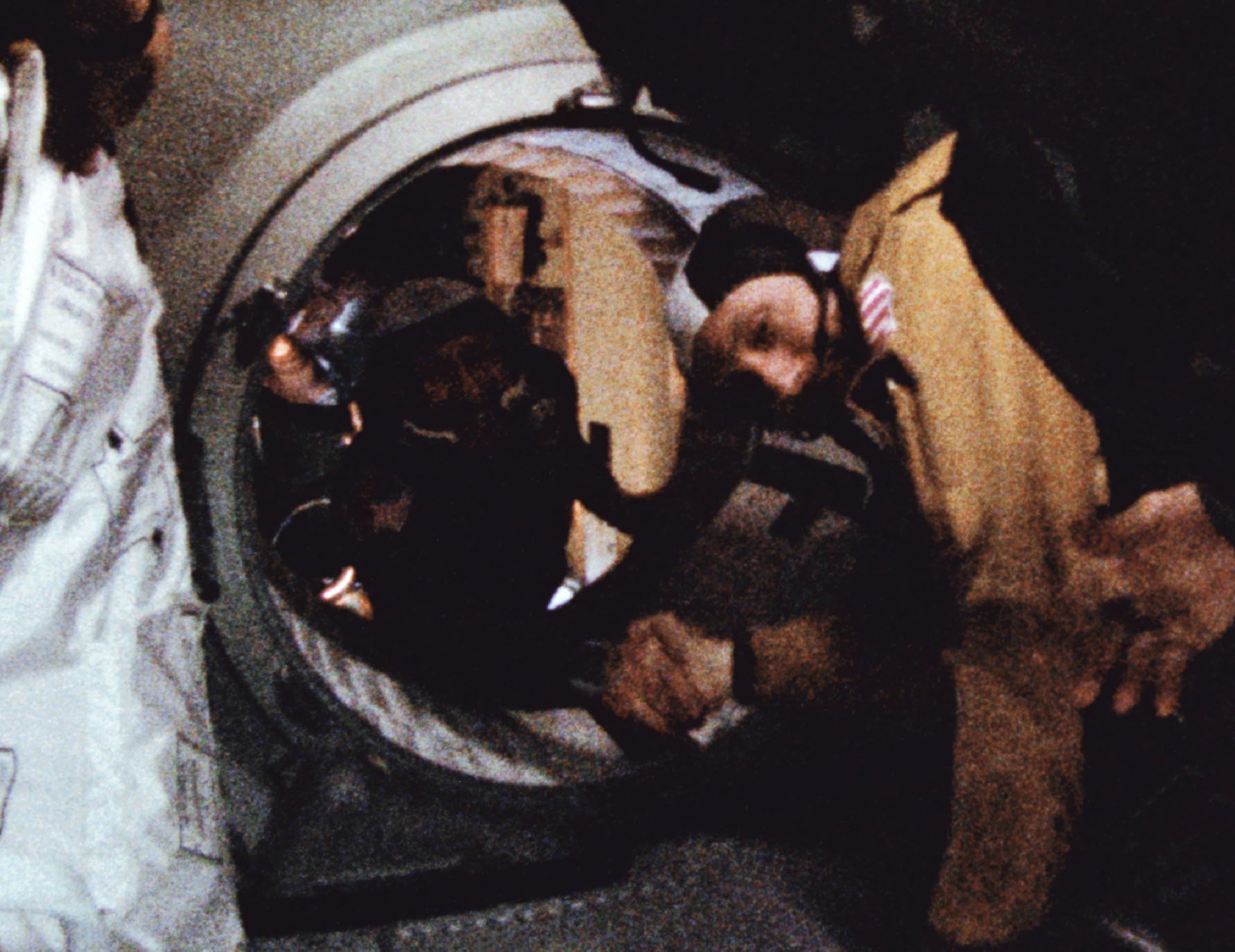Astronaut Thomas Stafford and cosmonaut Alexei Leonov shake hands in the hatchway between the docked Apollo and Soyuz spacecraft in Earth orbit, July 1975.