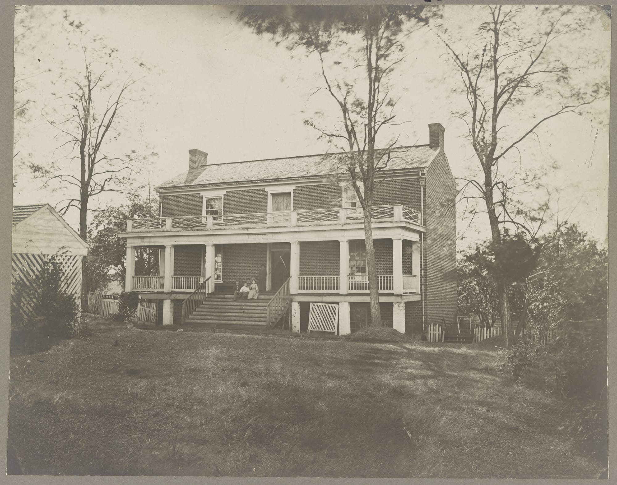 A contemporary photograph of the McLean house at Appomattox Court House, a brick building with a porch.