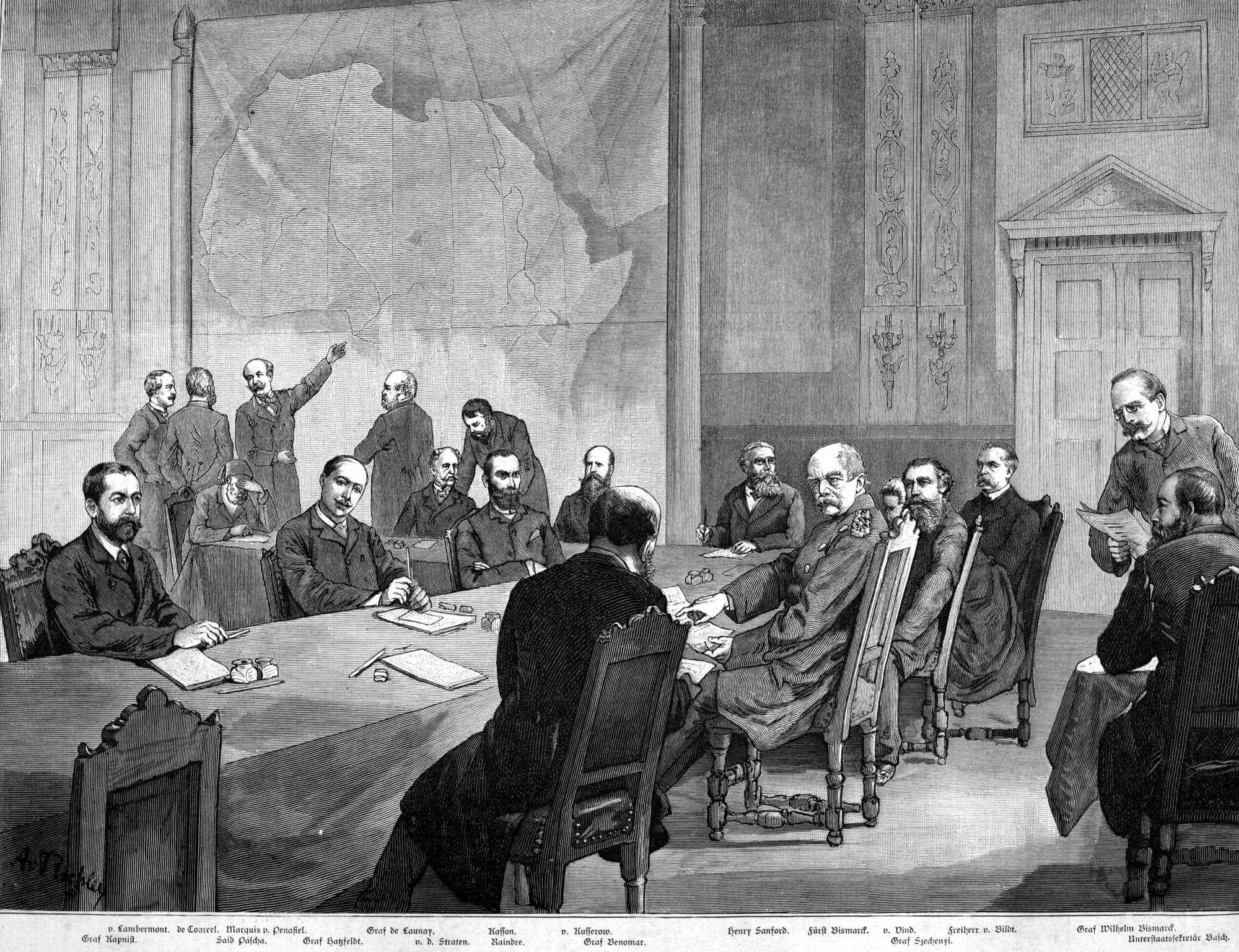A contemporary engraving of the Berlin Conference: delegates seated around a long table with a large map of Africa on the wall.