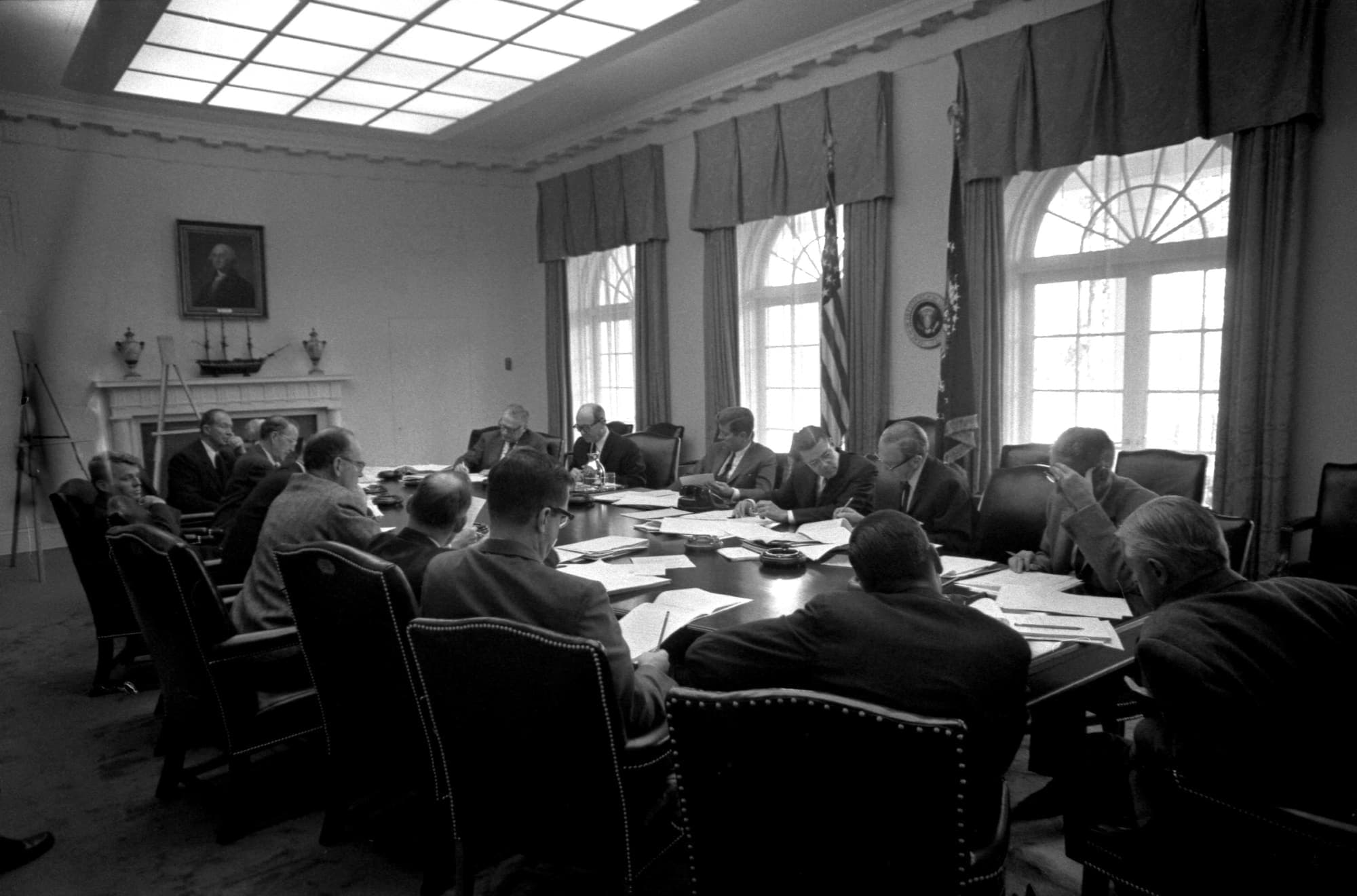 President Kennedy and the Executive Committee seated around the Cabinet Room table during the Cuban Missile Crisis.