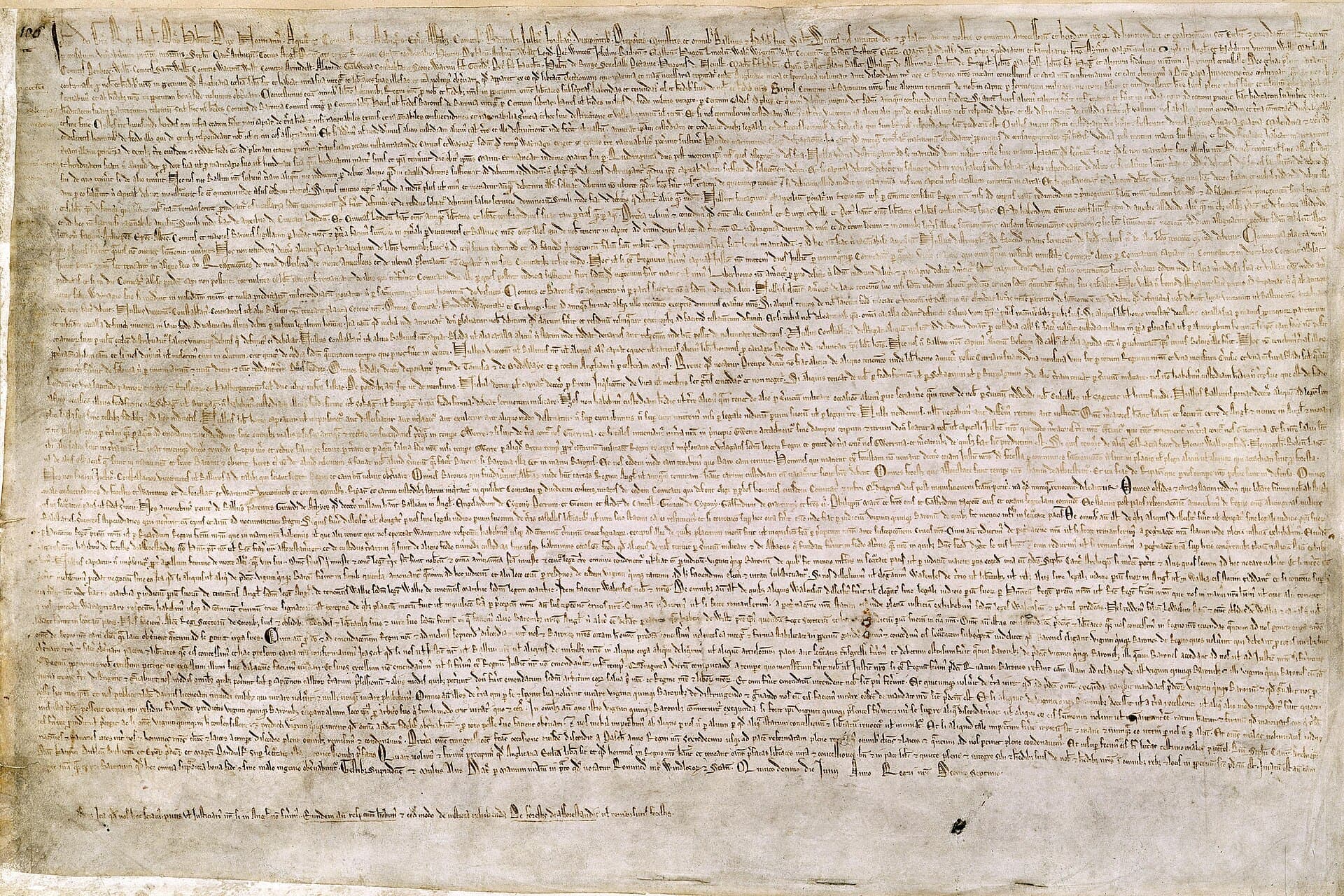 One of the surviving 1215 exemplars of Magna Carta: a sheet of parchment covered in dense medieval Latin script.